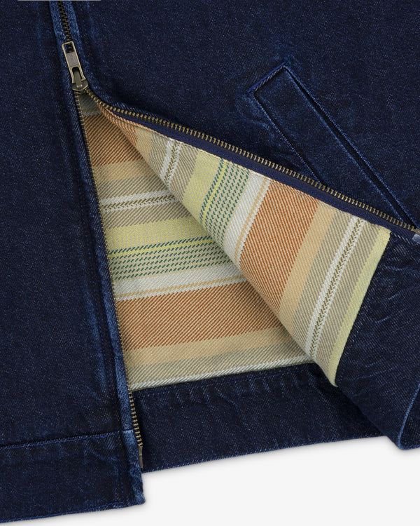 The Denim Zip Jacket is partially unzipped, showing a vibrant striped lining in yellow, green, and orange.