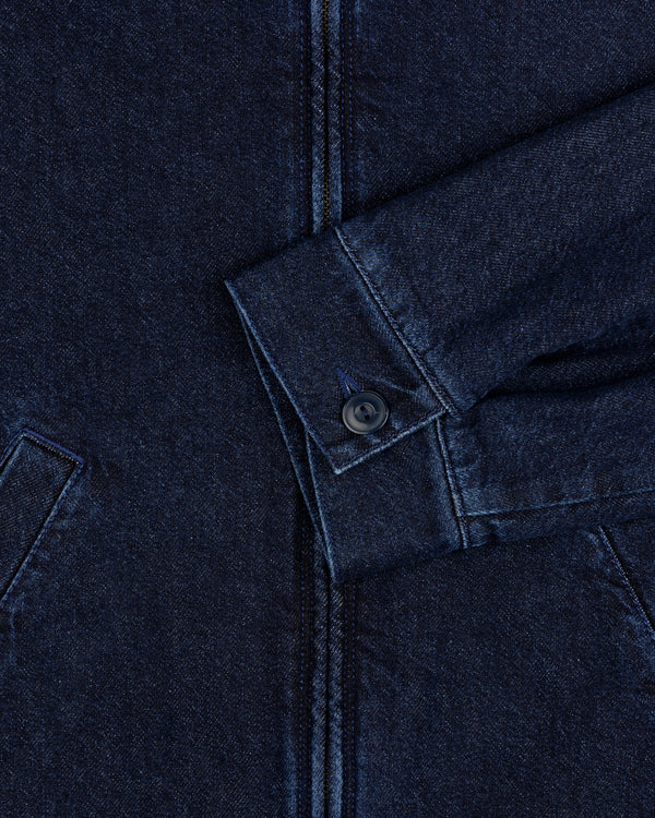 Close-up of Denim Zip Jacket sleeve in dark blue with visible buttoned cuff and partial front pockets.