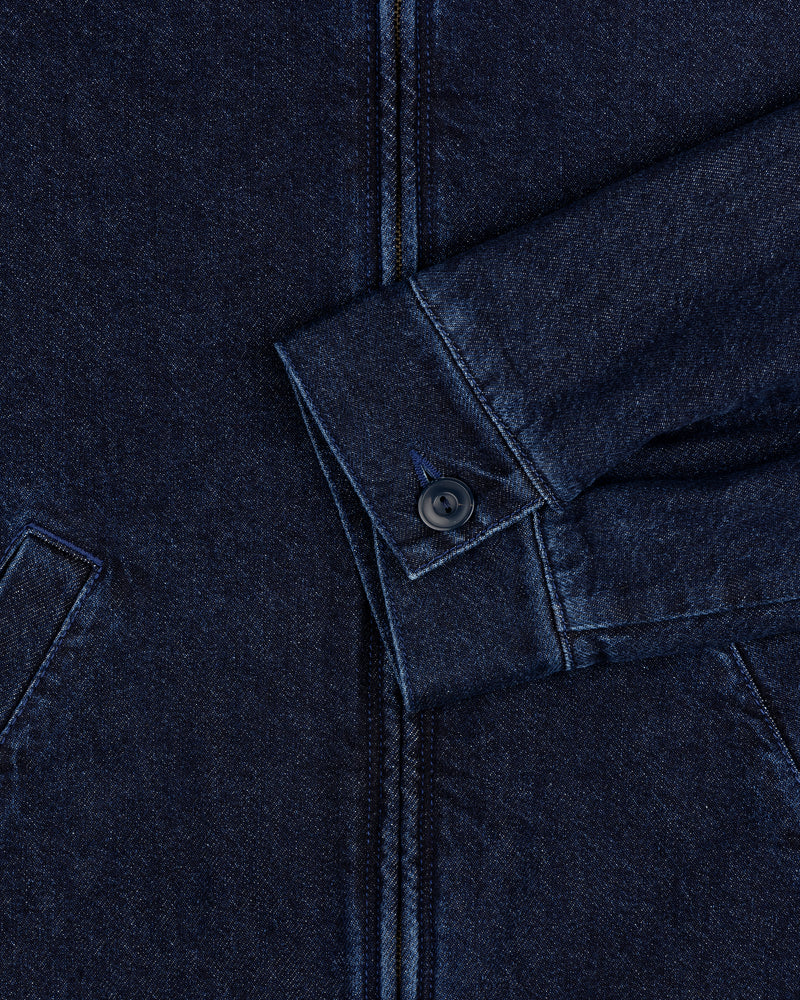 Close-up of Denim Zip Jacket sleeve in dark blue with visible buttoned cuff and partial front pockets.