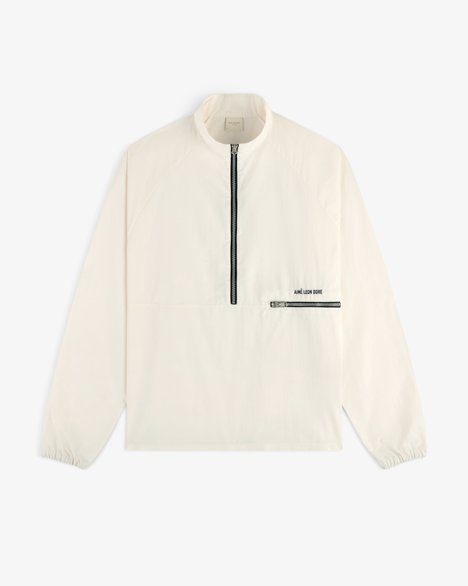 Off-white Nylon Packable Windbreaker with black half-zip, zip chest pocket, and AIMÉ LEON DORE text.