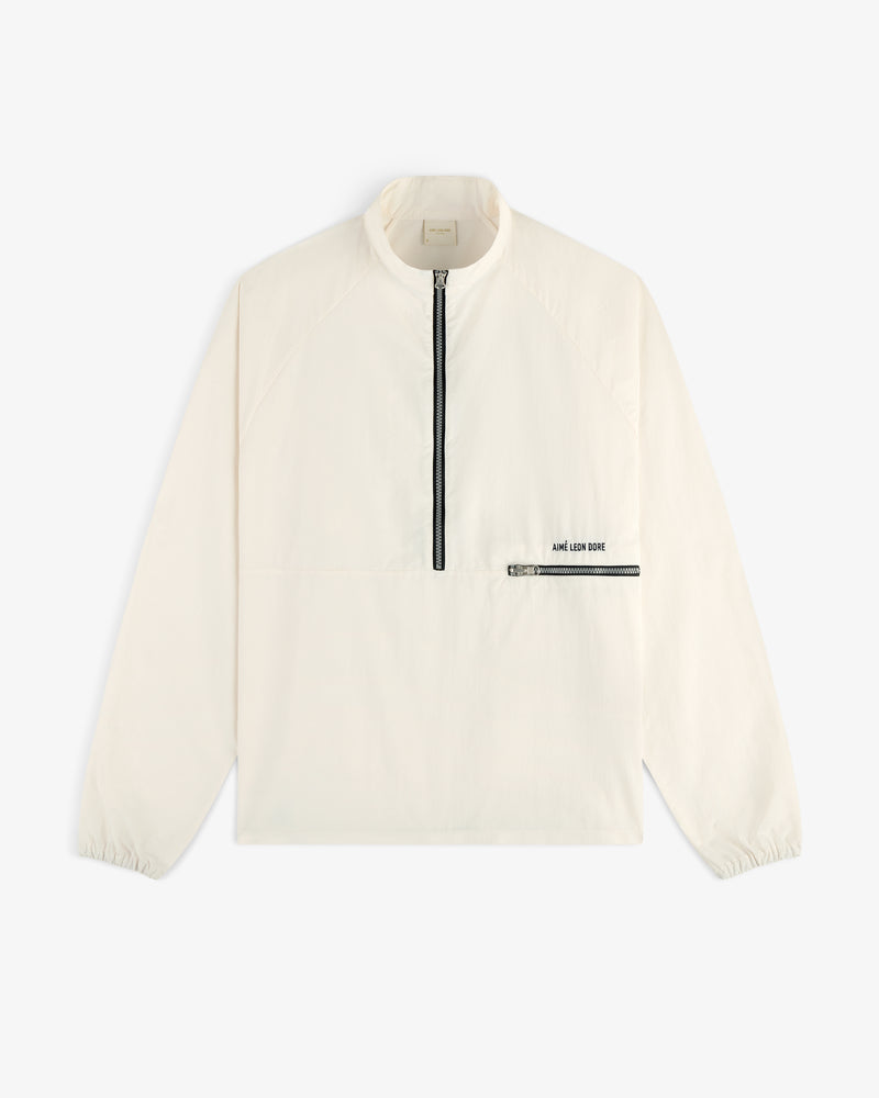 Off-white Nylon Packable Windbreaker with black half-zip, zip chest pocket, and AIMÉ LEON DORE text.