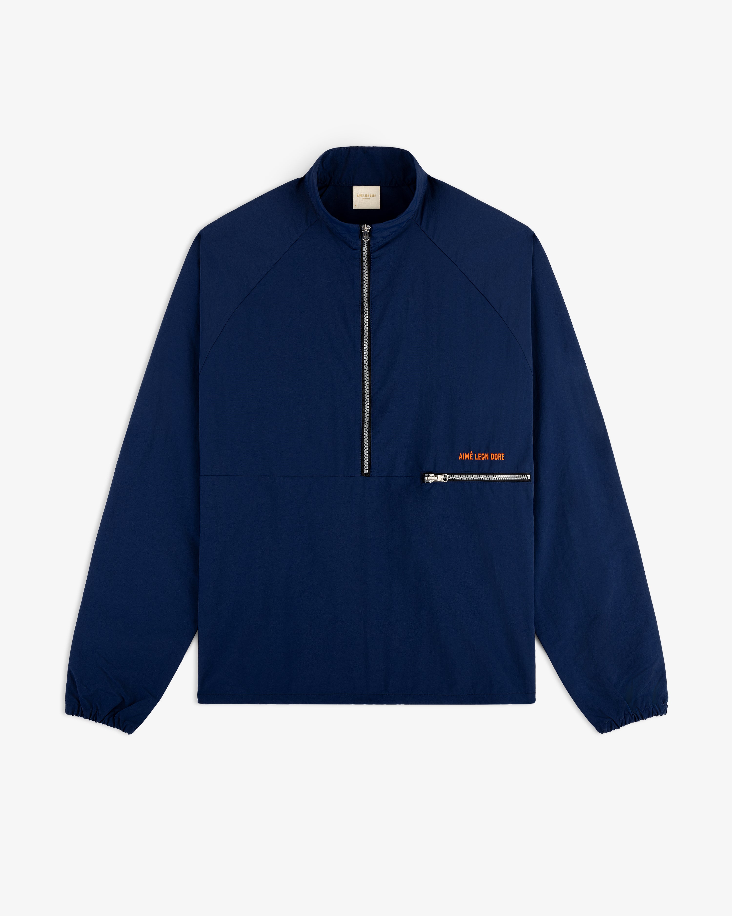 A navy Nylon Packable Windbreaker with a half-zip front, zip chest pocket, and small orange text.