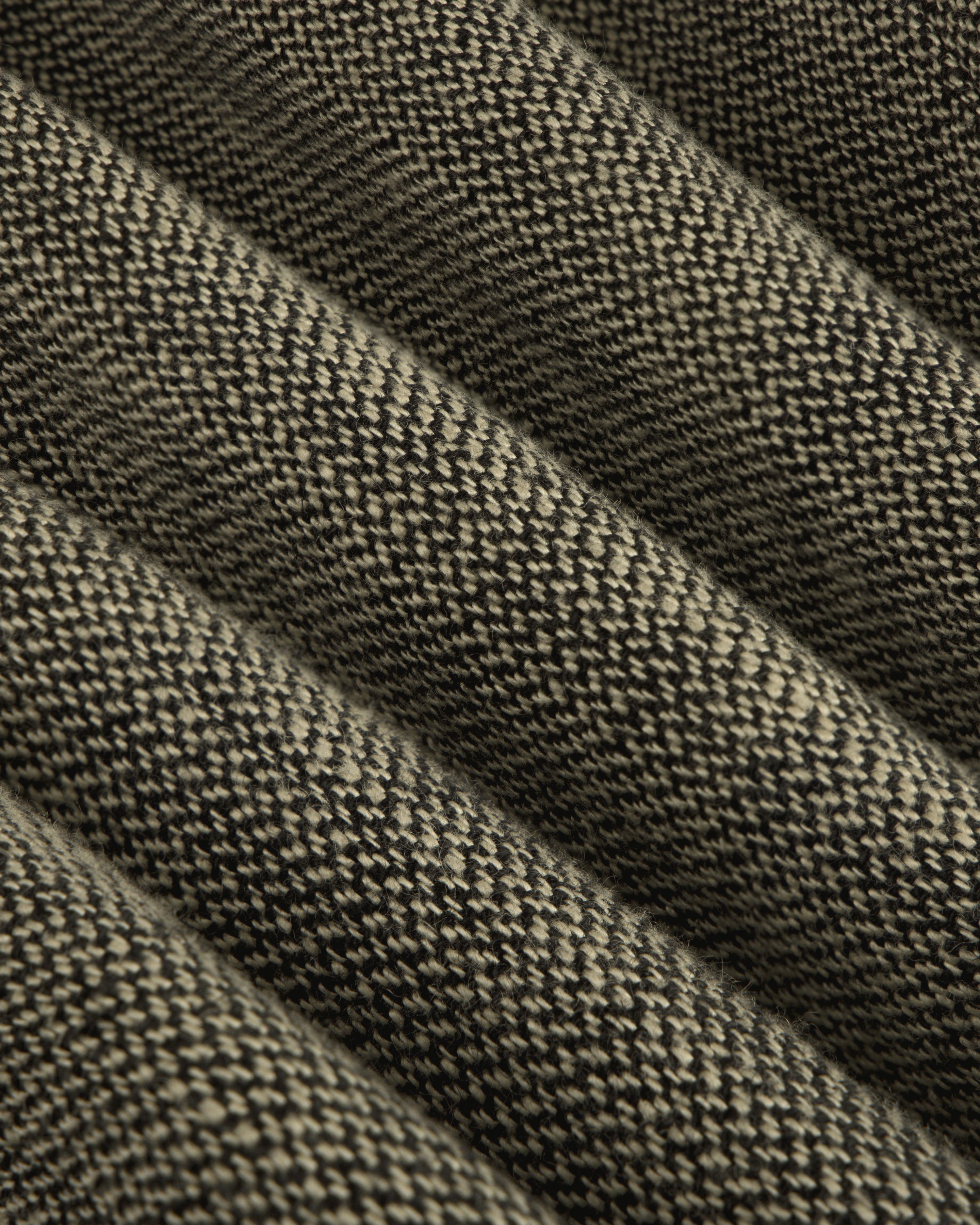 Close-up of ribbed, textured dark linen on the Single-Breasted Yarn Dyed Linen Suit Jacket with diagonal highlights.