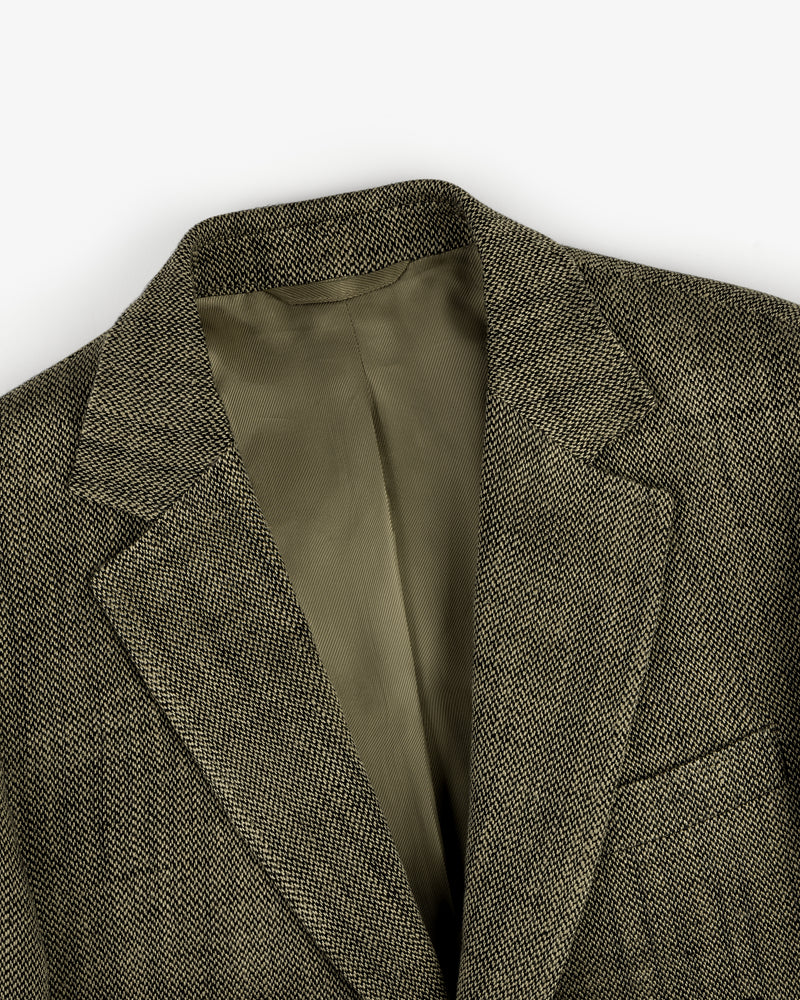 A close-up of the Single-Breasted Yarn Dyed Linen Suit Jacket with notched lapel and light brown lining.