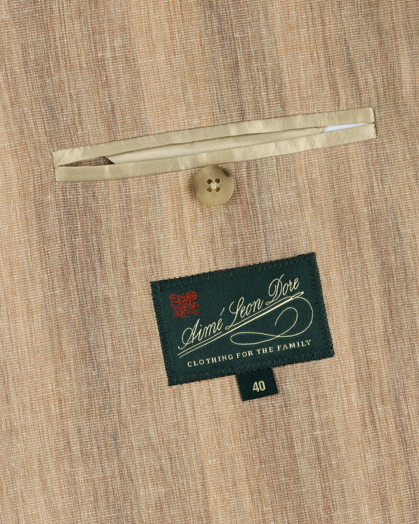 Close-up of a tan Single-Breasted Safari Suit Jacket pocket with a button and an Aimé Leon Dore label.