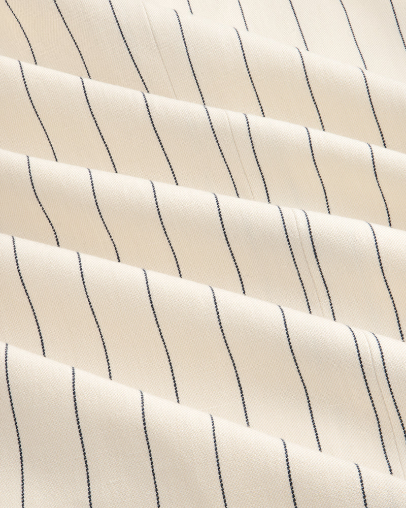 Close-up of Double-Breasted Pinstripe Suit Jacket in cream with evenly spaced thin black vertical stripes.