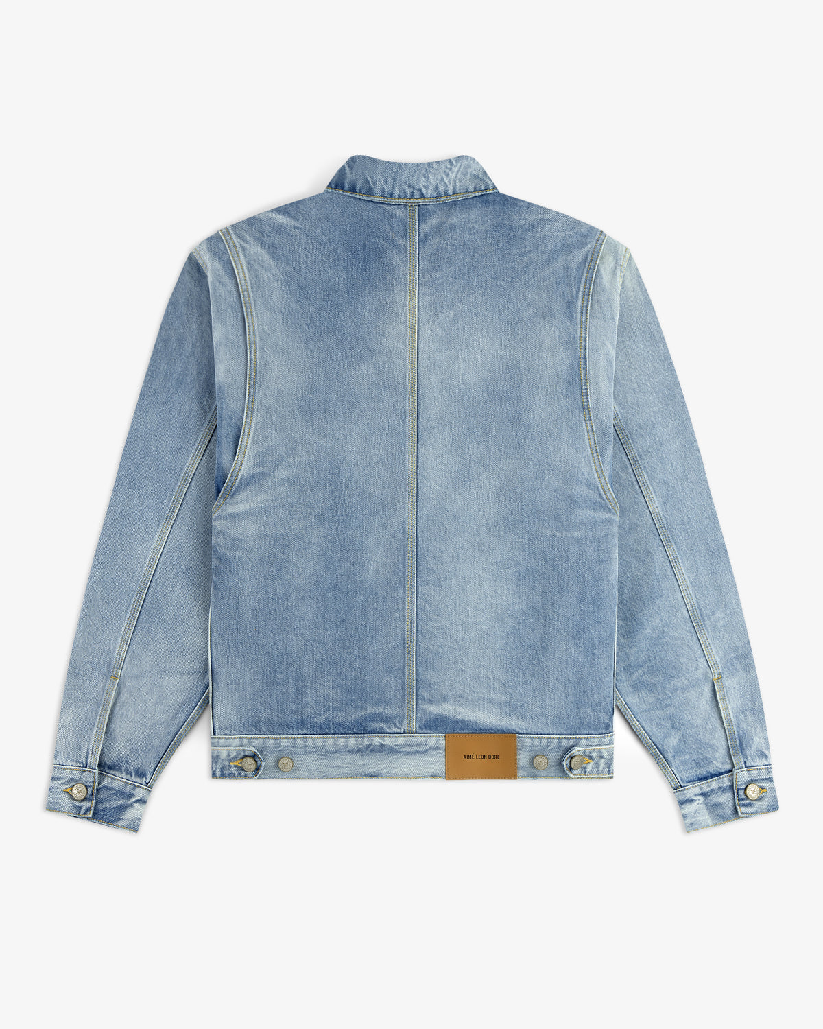 Denim Trucker Jacket in light blue, shown from the back with a brown leather patch near the waistband.