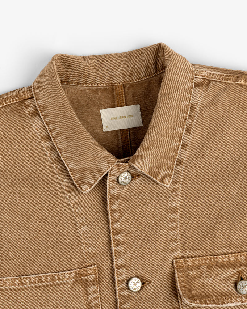 Tan Denim Trucker Jacket with silver buttons, chest pockets, and a visible white label inside the collar.