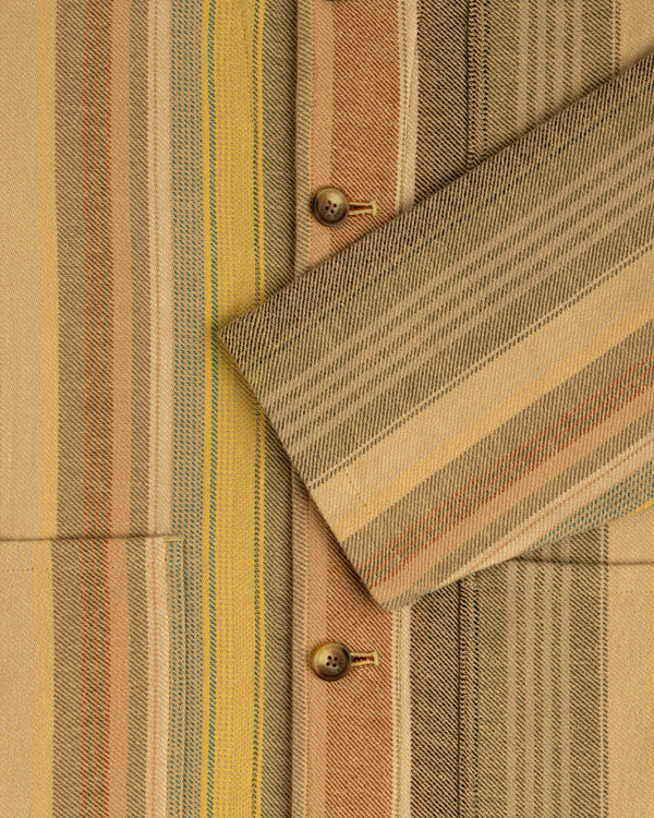 Close-up of the Blanket Striped Chore Jacket in beige and yellow stripes with brown buttons and angled pocket flap.