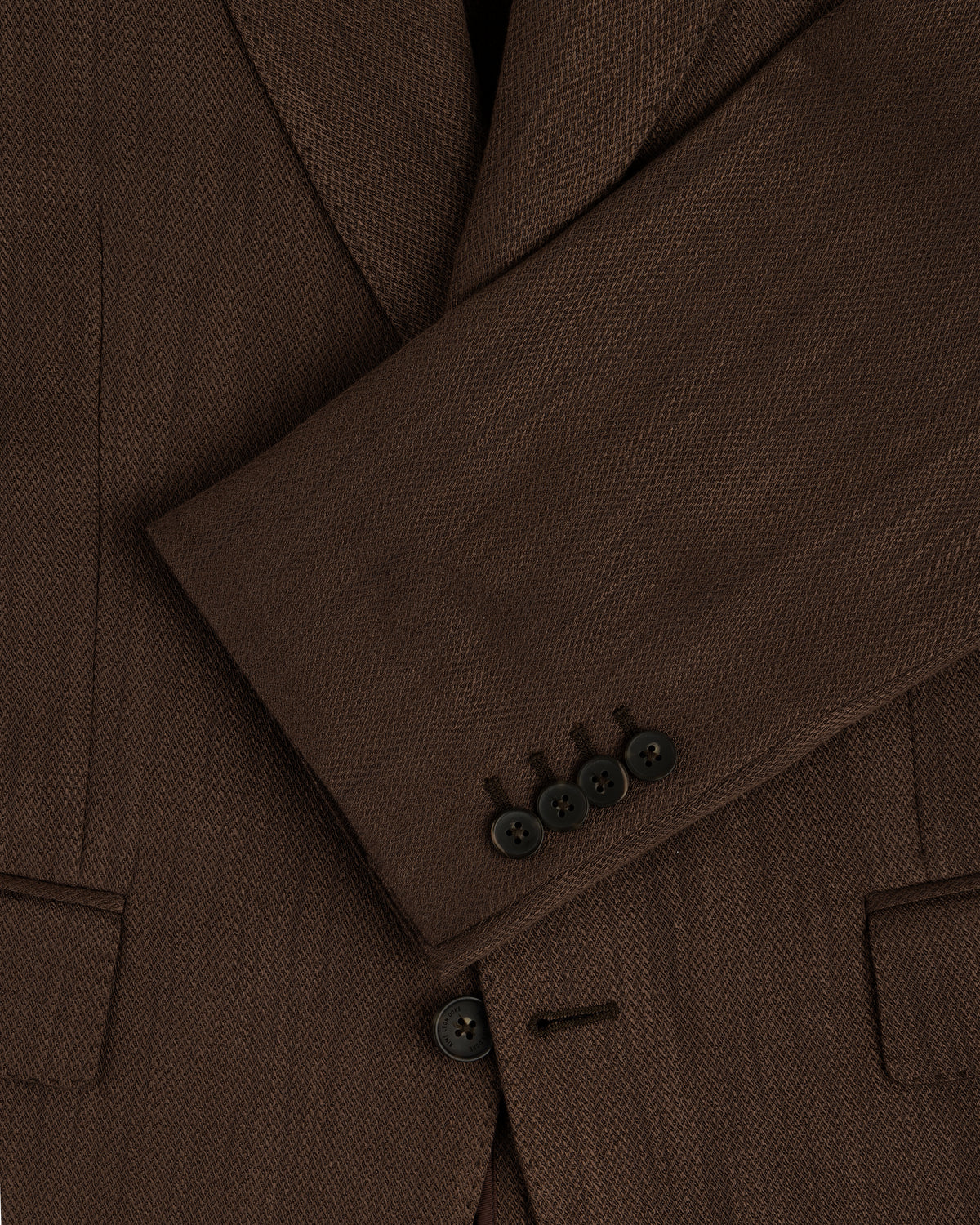 Close-up of the Single-Breasted Linen Blend Suit Jacket’s brown sleeve with four black buttons and two front pockets.
