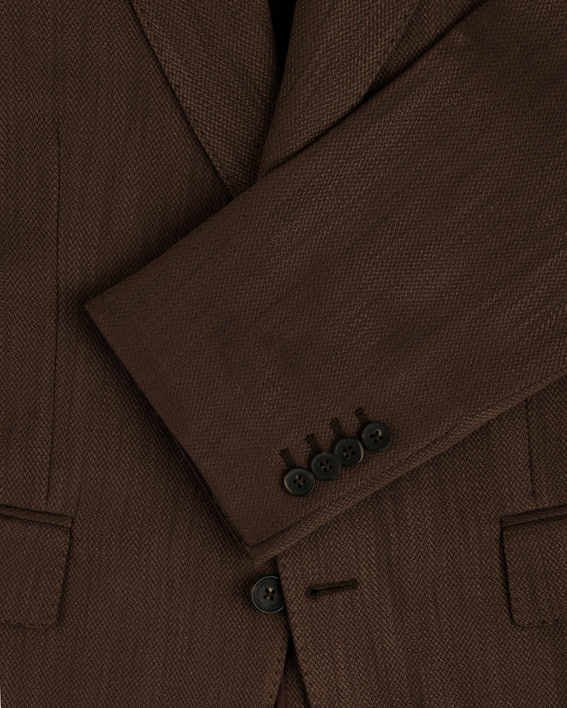 Close-up of the Single-Breasted Linen Blend Suit Jacket’s brown sleeve with four black buttons and two front pockets.