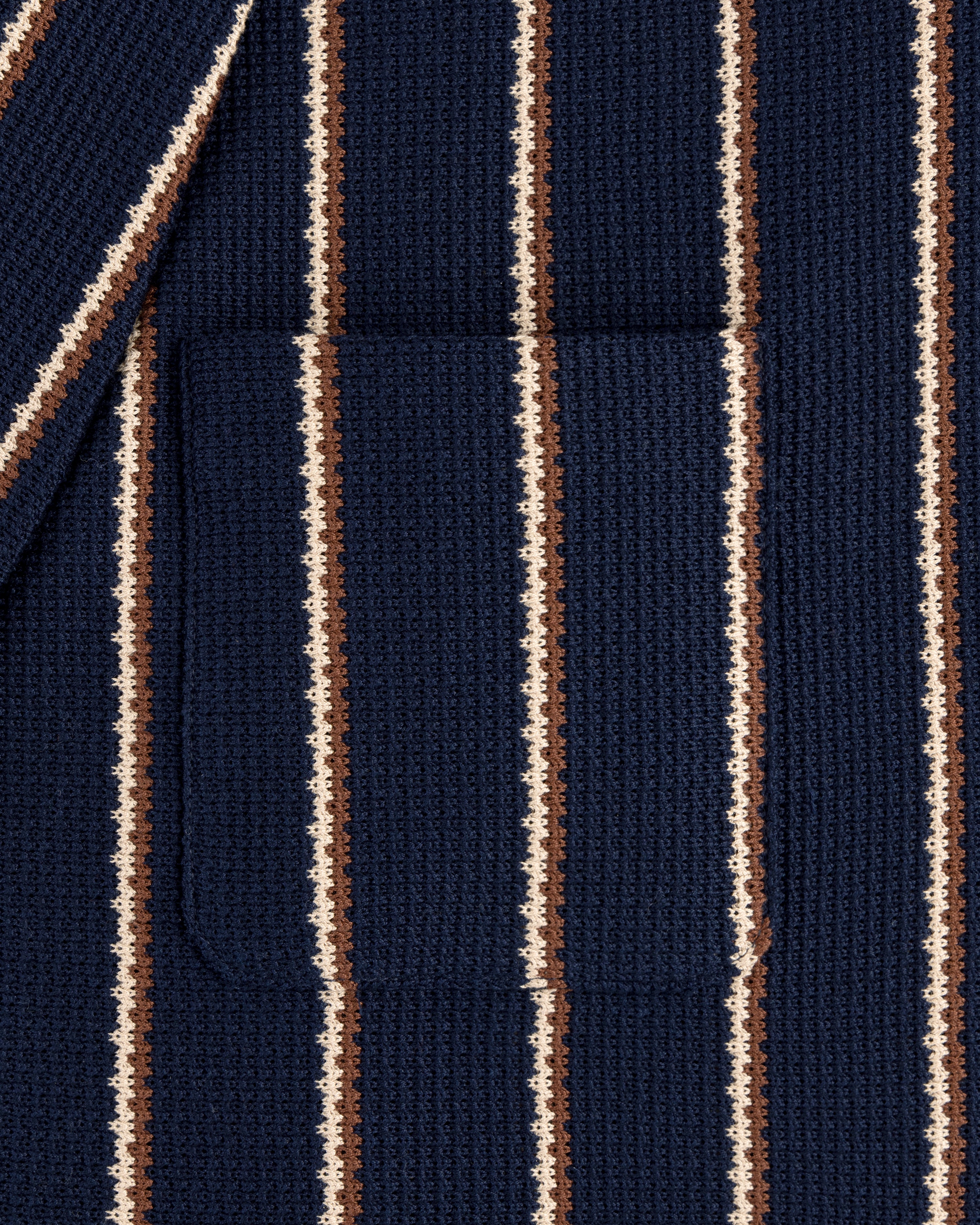 Close-up of Striped Jacquard Shawl Collar Jacket featuring vertical navy, brown, and cream stripes with a center pocket.