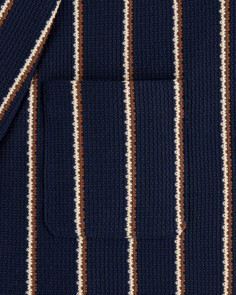 Close-up of Striped Jacquard Shawl Collar Jacket featuring vertical navy, brown, and cream stripes with a center pocket.