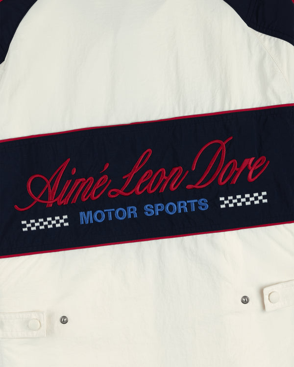 Nylon Moto Jacket with red Aimé Leon Dore script, blue Motor Sports text, and checkered flag details.