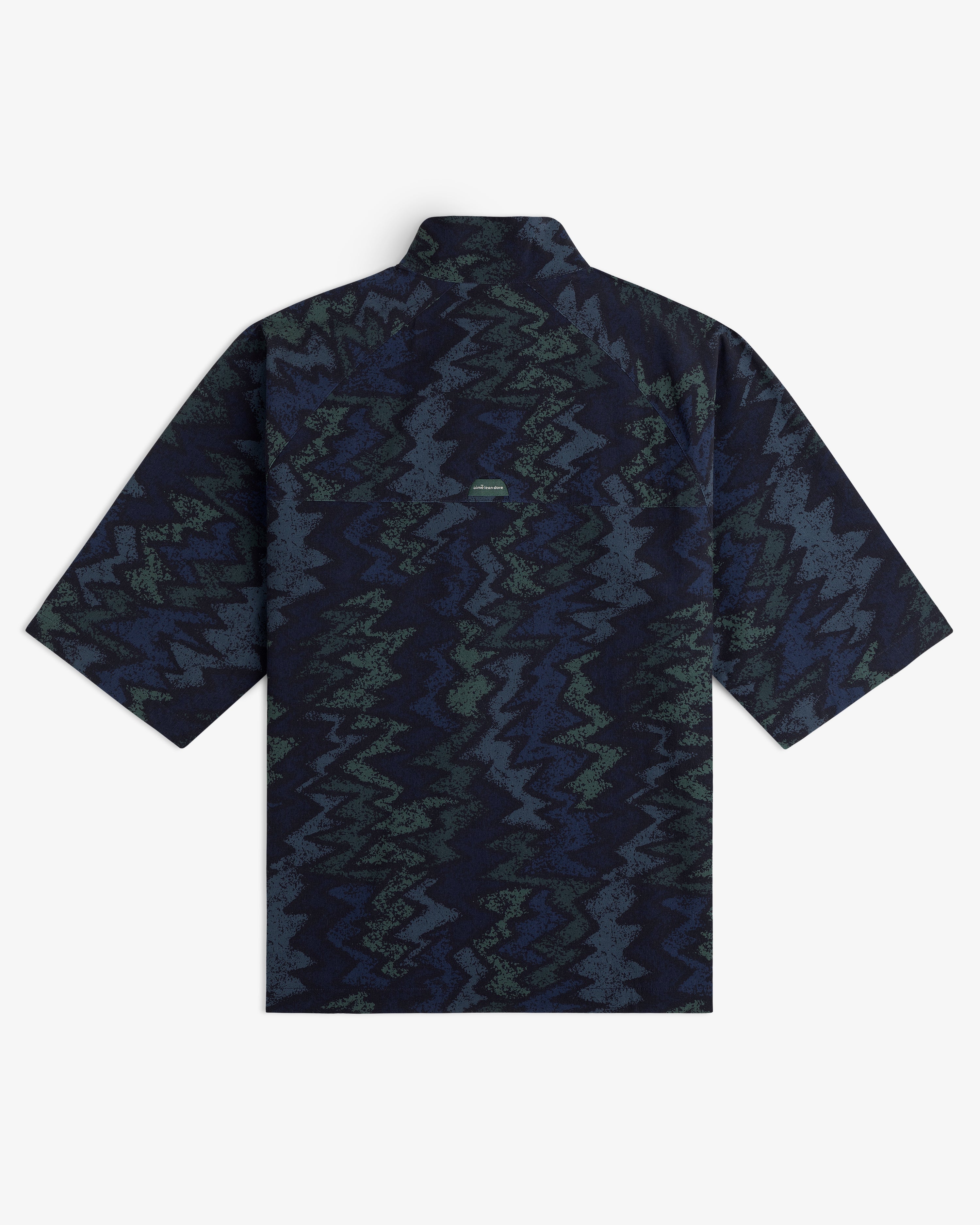 The ALD Golf Nylon Quarter Zip Pullover, shown flat from the back, features a navy, green, and gray zigzag pattern.