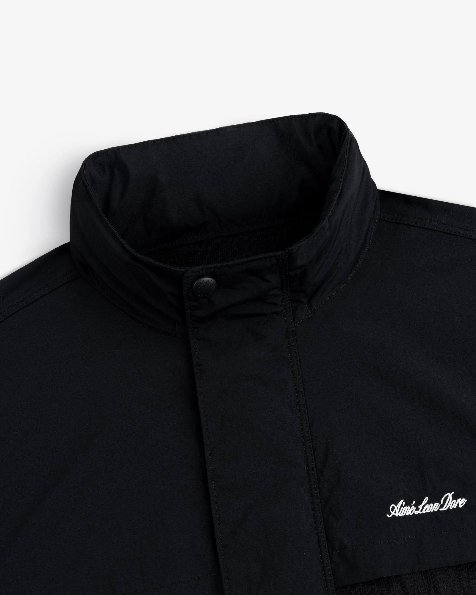 Nylon Track Jacket with high collar and snap button, “Aimé Leon Dore” embroidered in white on the chest.