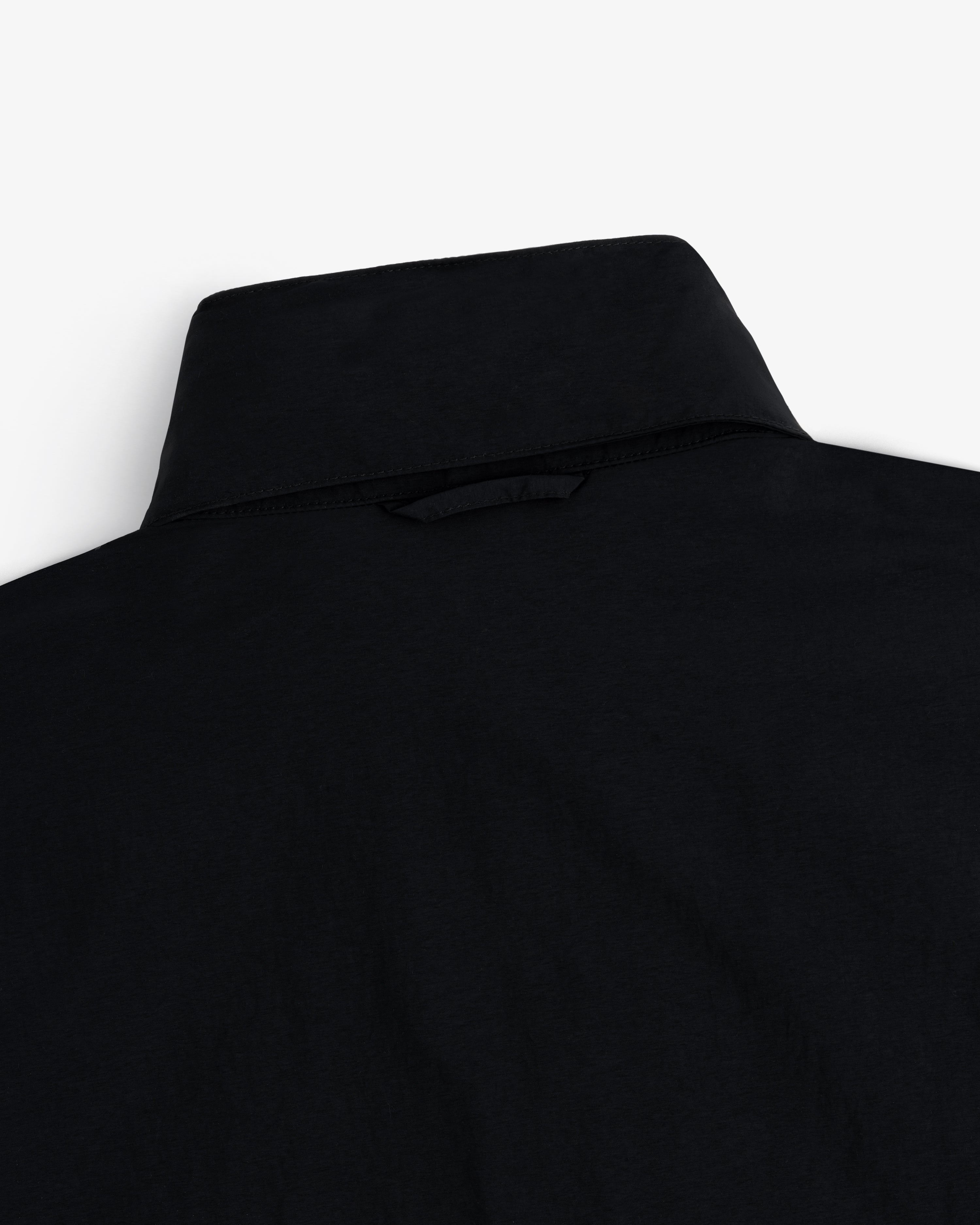 Close-up of the back of a Nylon Track Jacket, highlighting the collar and upper back fabric on a white background.