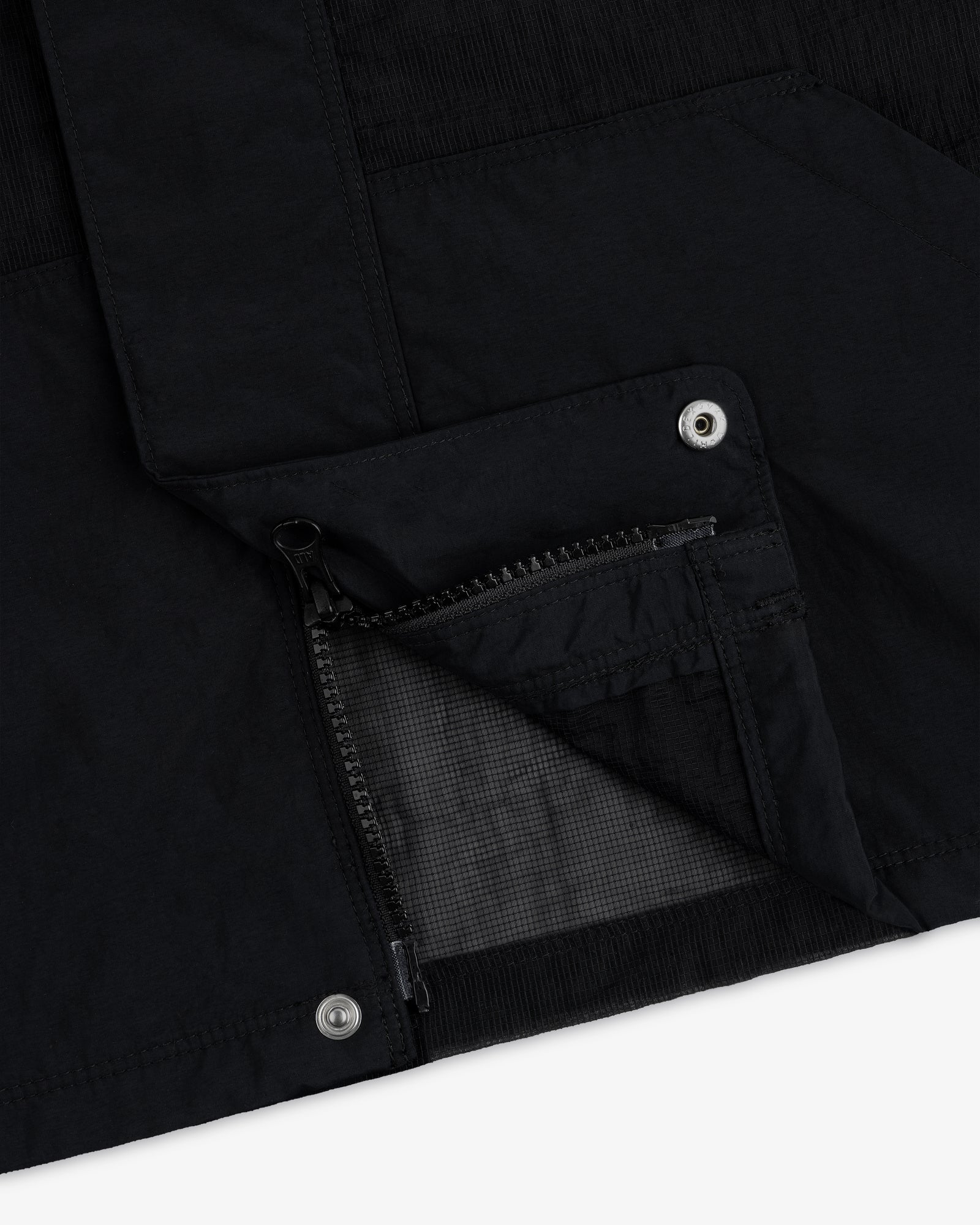 Close-up of the Nylon Track Jacket featuring an open zippered pocket and metal snap button details.