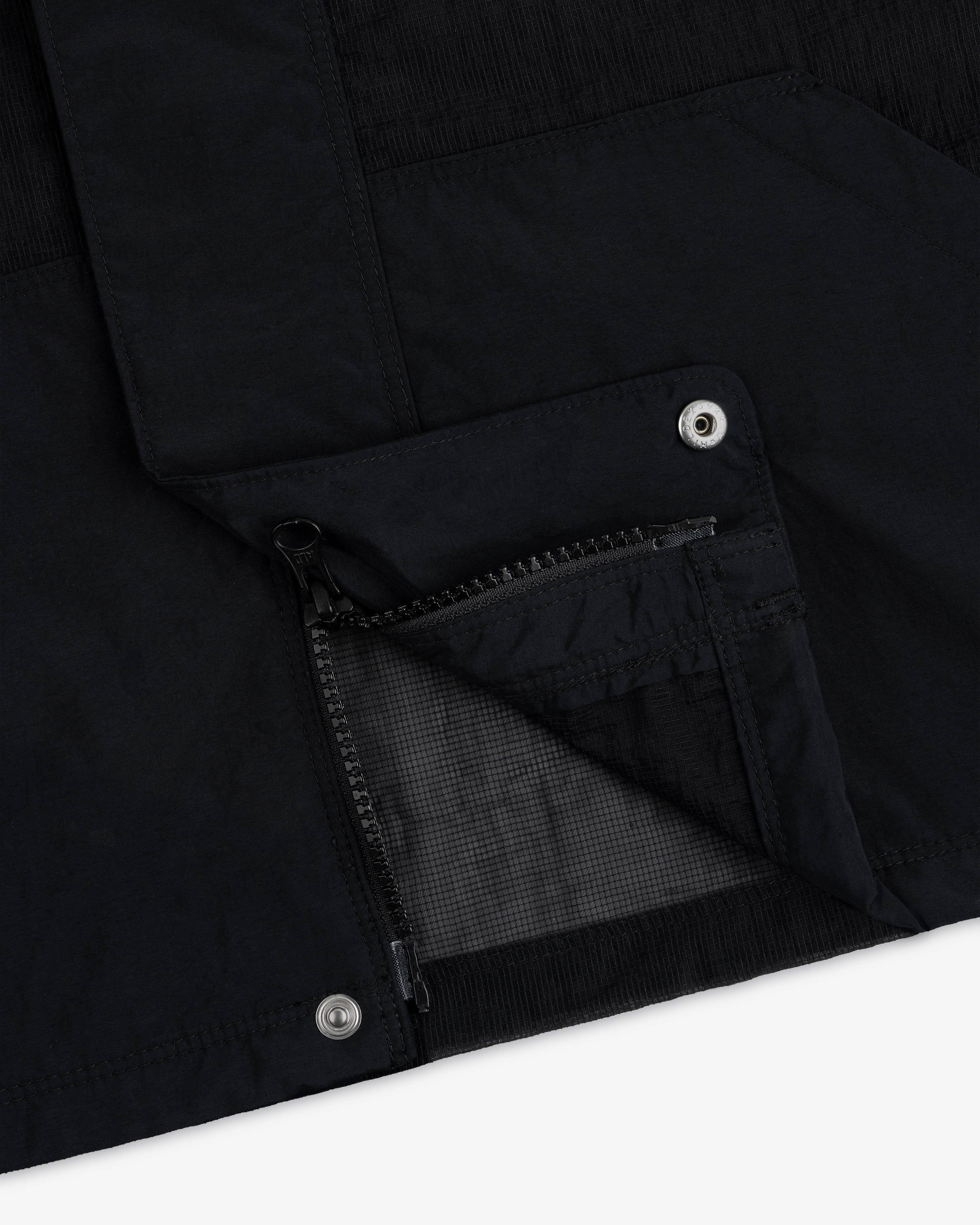 Close-up of the Nylon Track Jacket featuring an open zippered pocket and metal snap button details.
