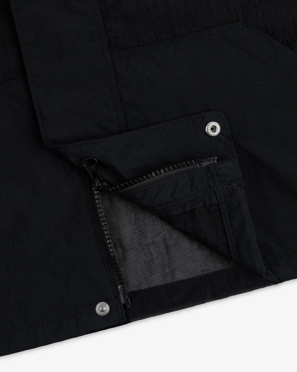 Close-up of the Nylon Track Jacket featuring an open zippered pocket and metal snap button details.