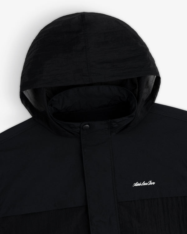 Black Nylon Track Jacket with hood, snap buttons, and small white Adventure Pro logo on the chest.