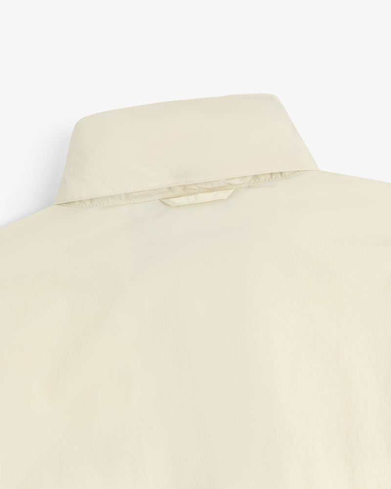Close-up of the back of a beige Nylon Track Jacket, highlighting the collar and upper back details.