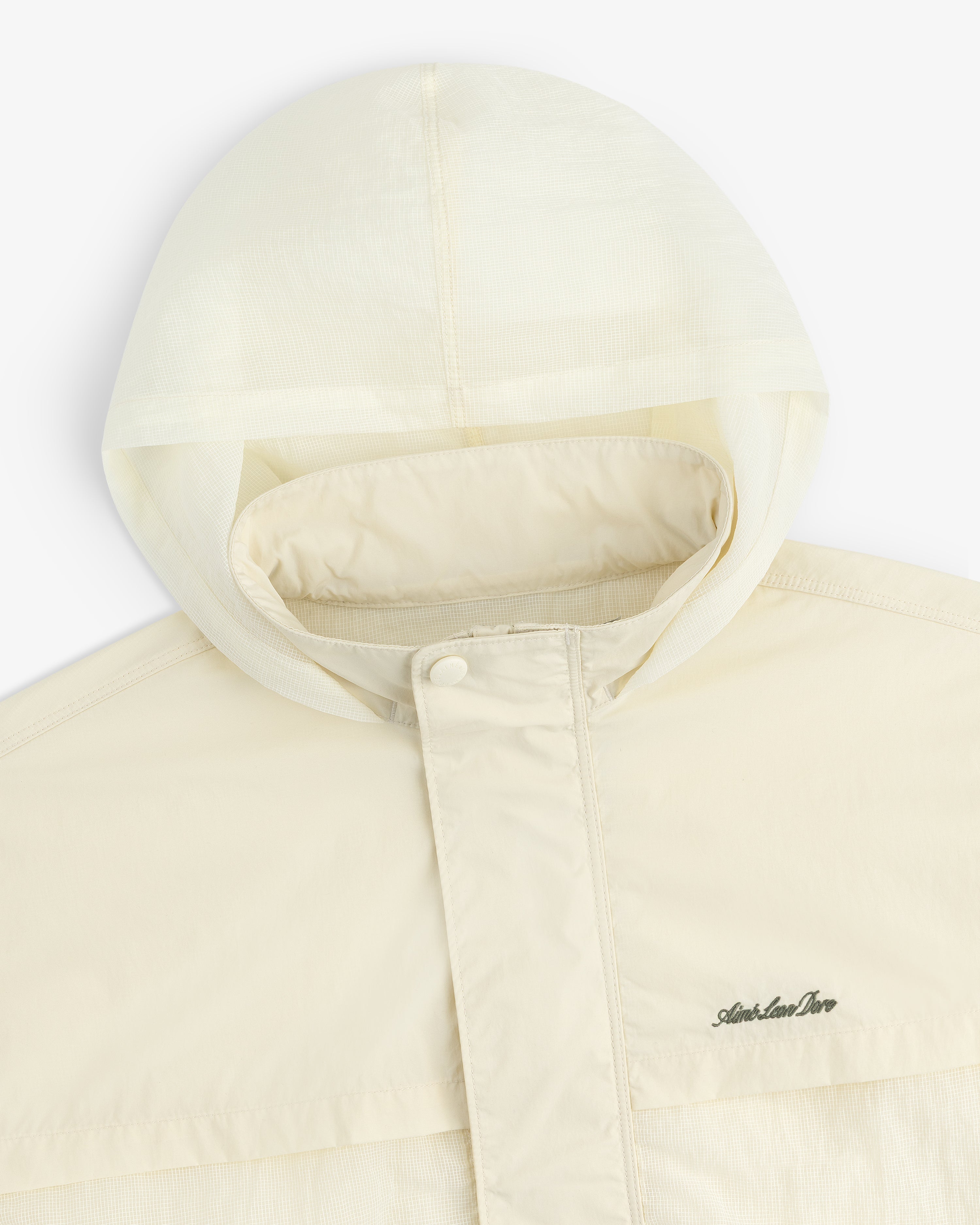Cream-colored Nylon Track Jacket with a hood, snap-button placket, and Arlen Ness logo on the chest.