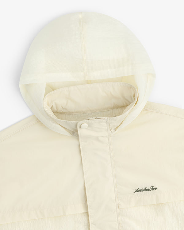 Cream-colored Nylon Track Jacket with a hood, snap-button placket, and Arlen Ness logo on the chest.