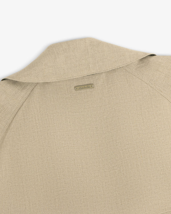 Close-up of the back and collar of the Linen Trench Coat, featuring a small rectangular label at the neck.