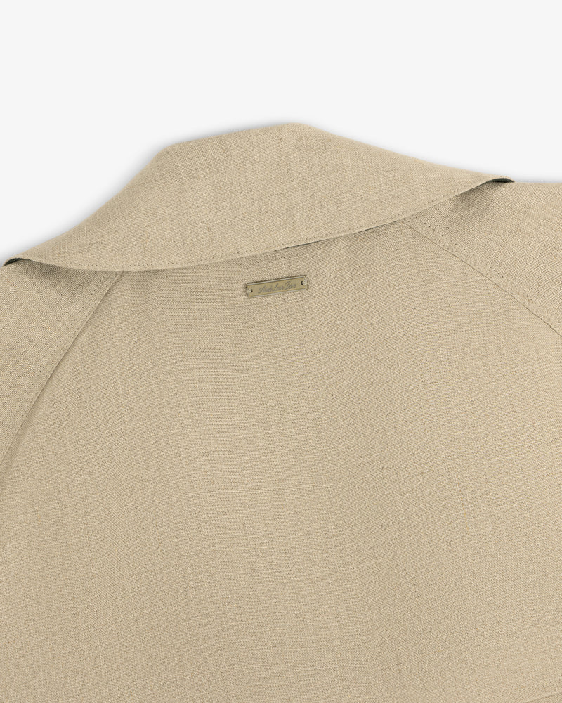 Close-up of the back and collar of the Linen Trench Coat, featuring a small rectangular label at the neck.