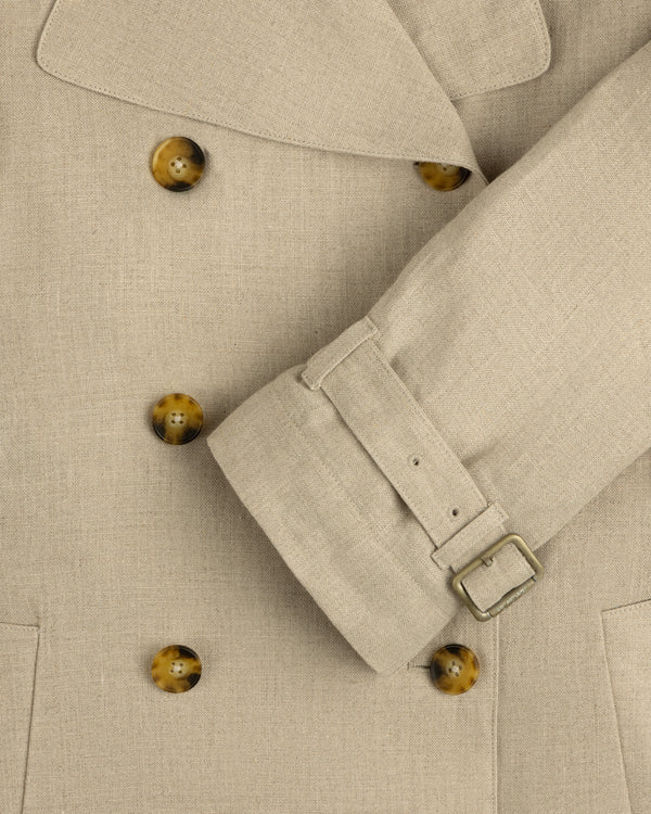 Close-up of the Linen Trench Coat featuring brown buttons and belted sleeve detail.