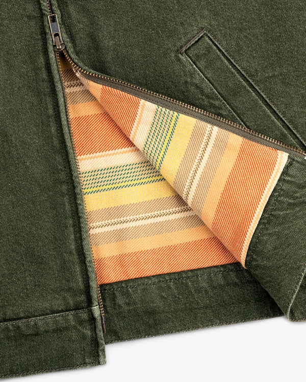 Close-up of a Denim Zip Jacket in green, partially unzipped to show a multicolored striped inner lining.