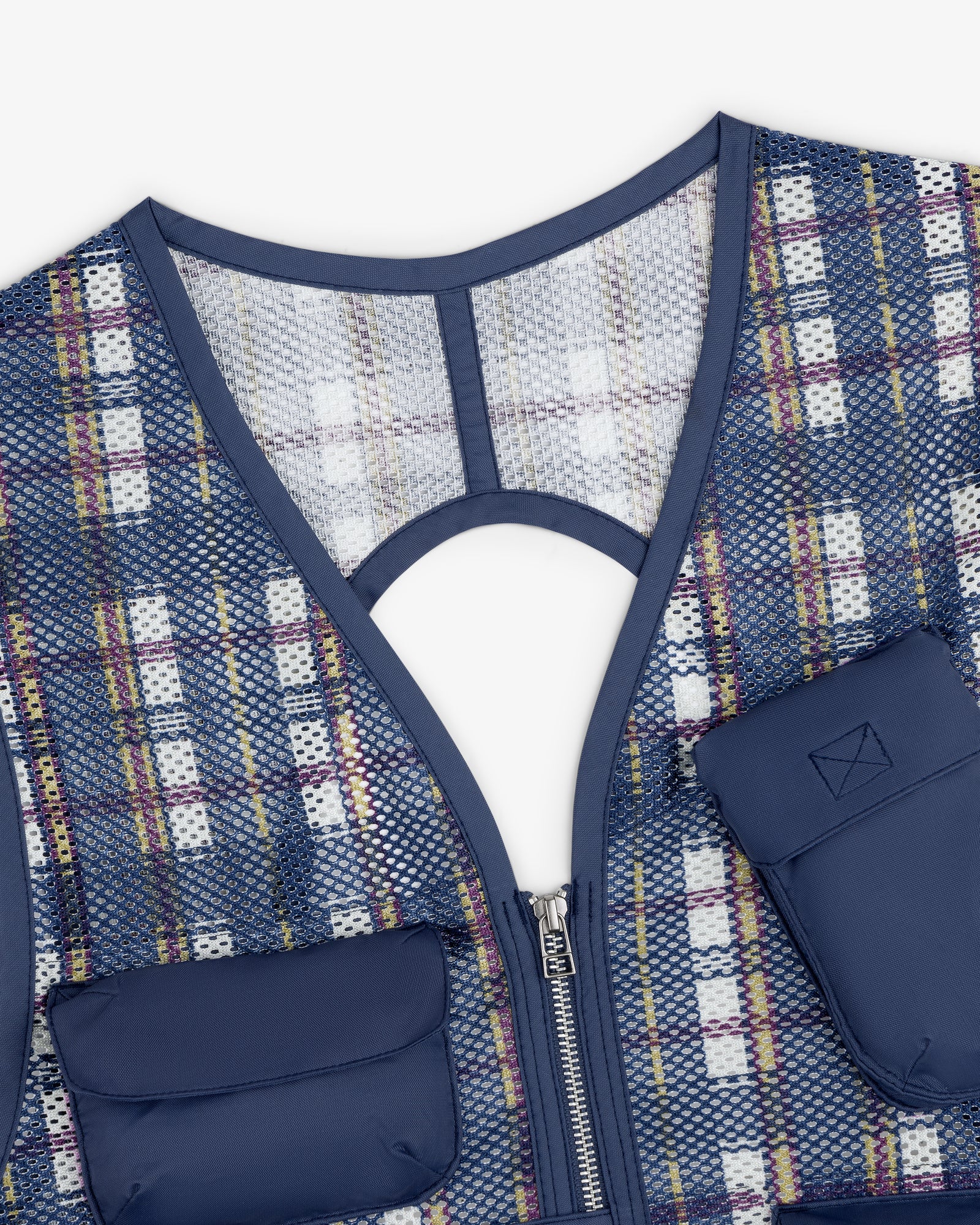 Close-up of the Nylon Madras Utility Vest with navy trim, zipper, two padded pockets, and a round back cutout.
