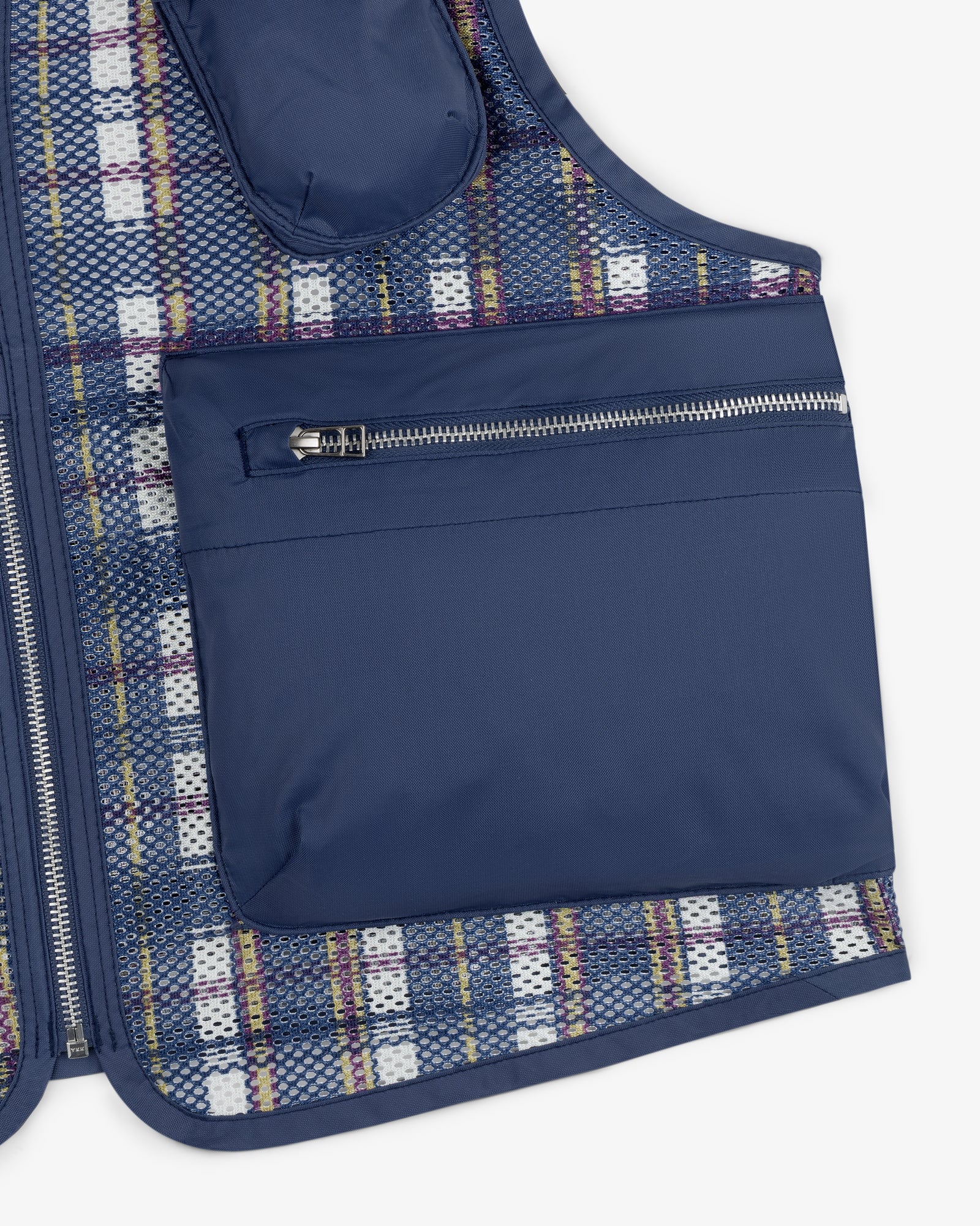 Close-up of the Nylon Madras Utility Vest featuring a large zippered pocket and plaid mesh lining.
