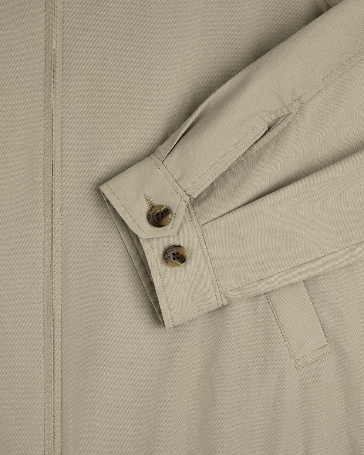 Close-up of Crest Casual Jacket sleeve in beige with two brown buttons and a visible side seam.