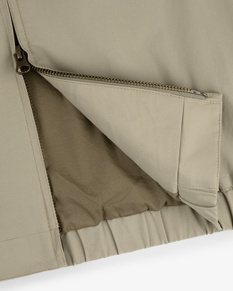 Close-up of Crest Casual Jacket in beige, highlighting its open zippered pocket with fabric lining.