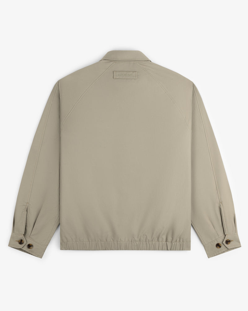 Crest Casual Jacket in beige, shown from the back with long sleeves, buttoned cuffs, and an elasticated hem.