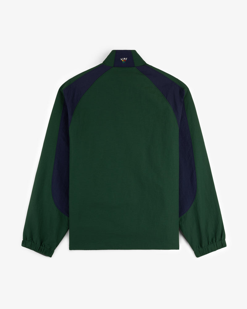 Crest Nylon Half-Zip Pullover in dark green with navy shoulder/side panels, long sleeves, and elastic cuffs (back view).