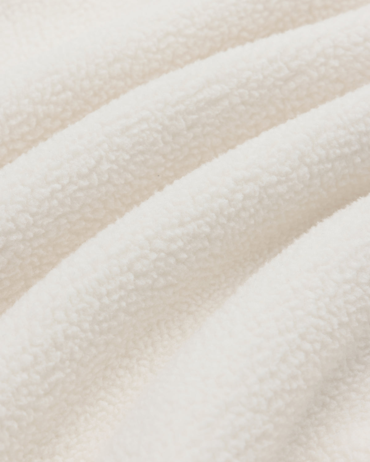Closeup of soft, cream-colored Crest Quarter-Zip Fleece Pullover with a textured, wavy fleece surface.