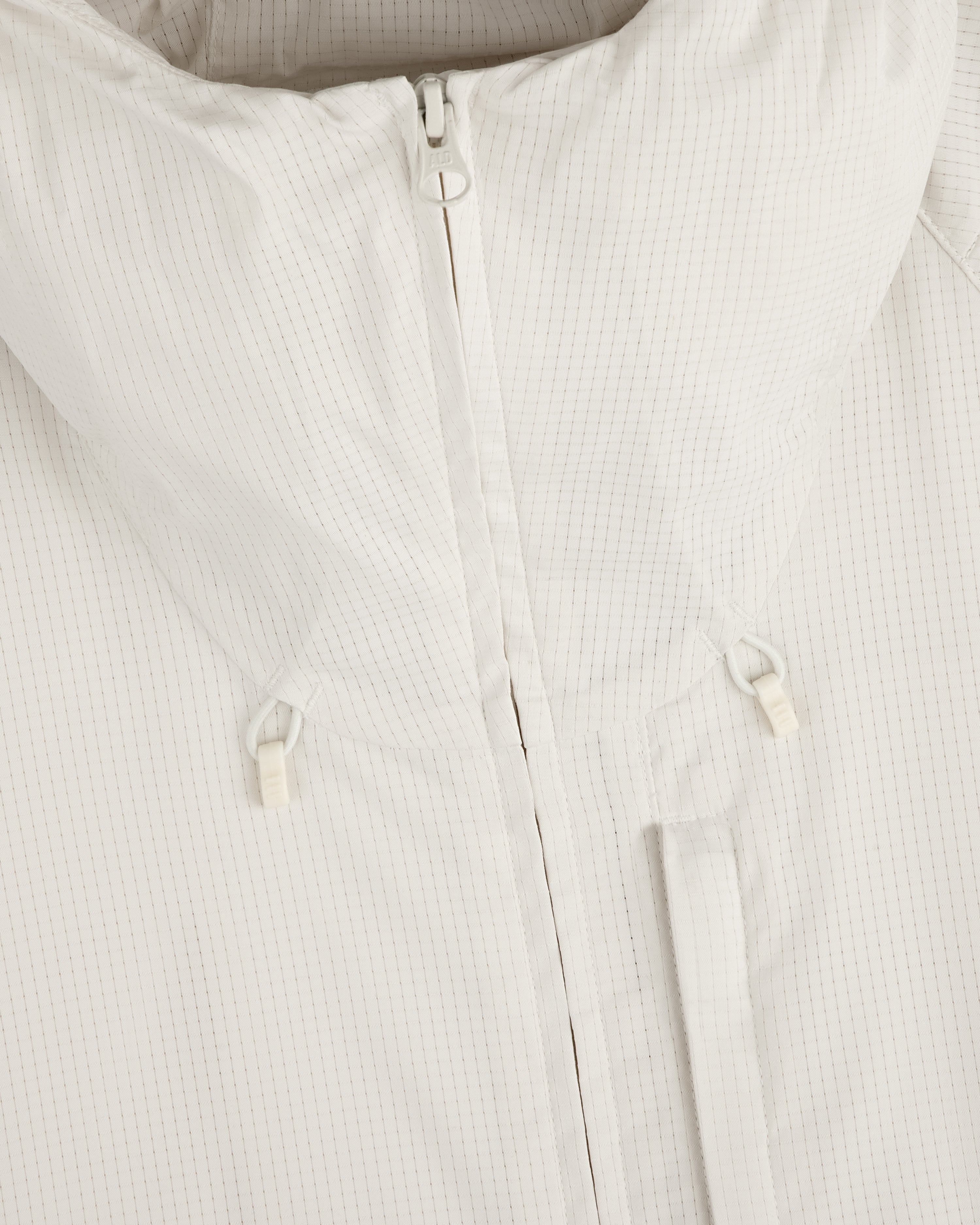 Close-up of the ALD Golf Lightweight Tips Windbreaker in white, featuring a zipper, high collar, and small drawstrings.
