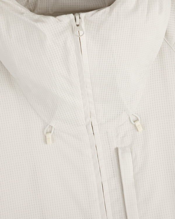 Close-up of the ALD Golf Lightweight Tips Windbreaker in white, featuring a zipper, high collar, and small drawstrings.