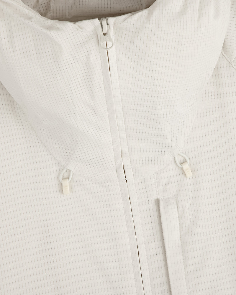 Close-up of the ALD Golf Lightweight Tips Windbreaker in white, featuring a zipper, high collar, and small drawstrings.