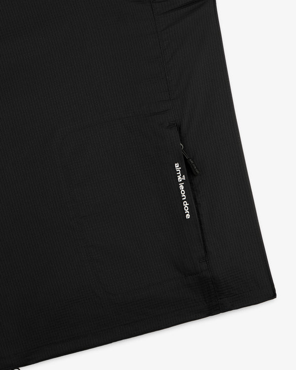 Close-up of a black ALD Golf Lightweight Tips Windbreaker pocket with a zipper and white Aimé Leon Dore text.