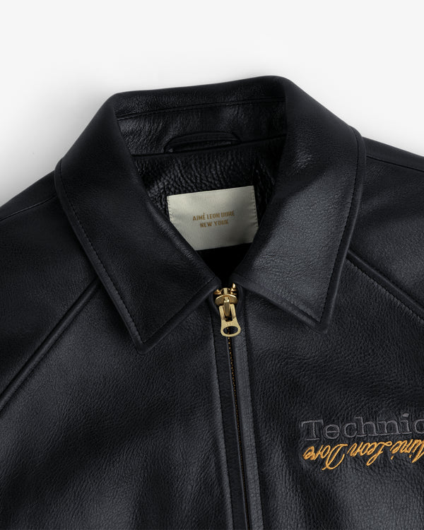 ALD / Technics Varsity Leather Jacket: black leather with gold zipper, “Aime Leon Dore, New York” label inside collar.