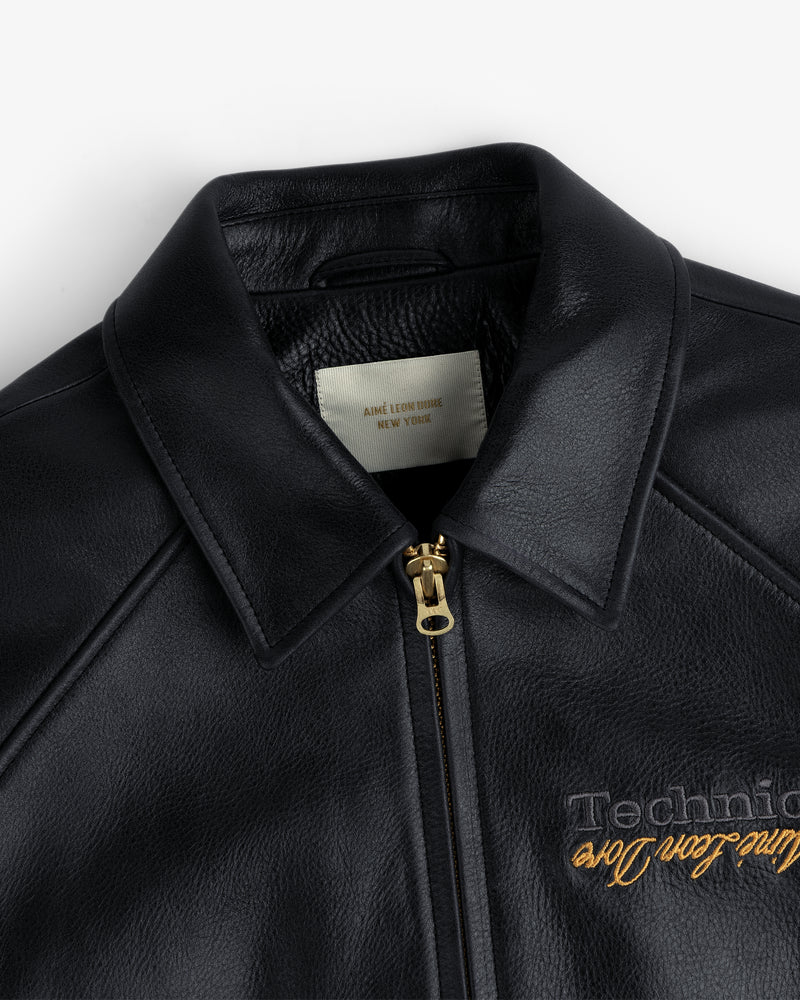ALD / Technics Varsity Leather Jacket: black leather with gold zipper, “Aime Leon Dore, New York” label inside collar.