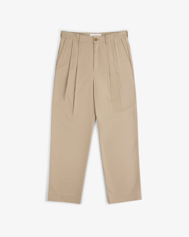 Double Pleated Pant in beige with button and zip closure, two side pockets, and straight legs on white background.
