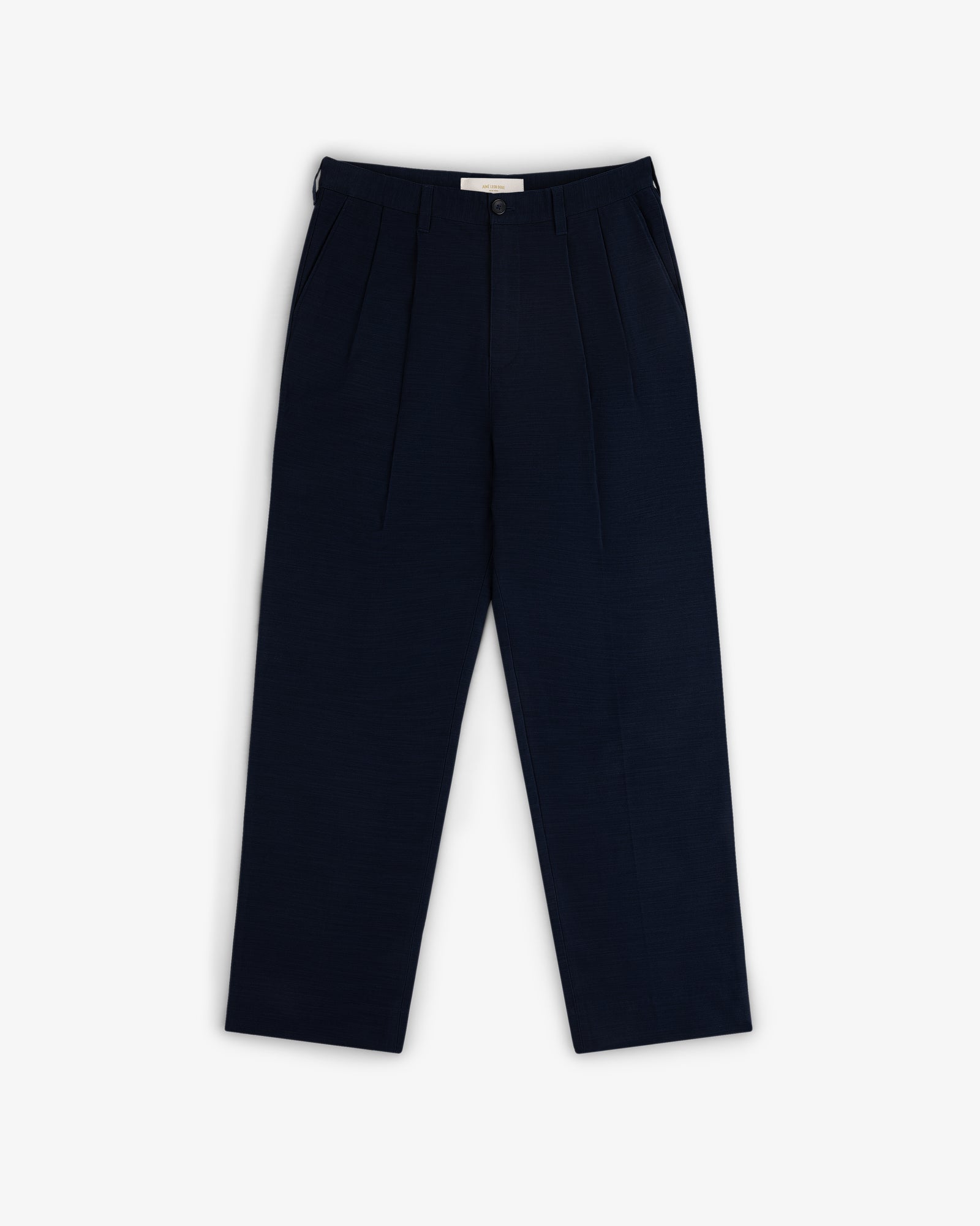 Double Pleated Pant in navy blue with button and zip closure, shown laid flat on a white background.