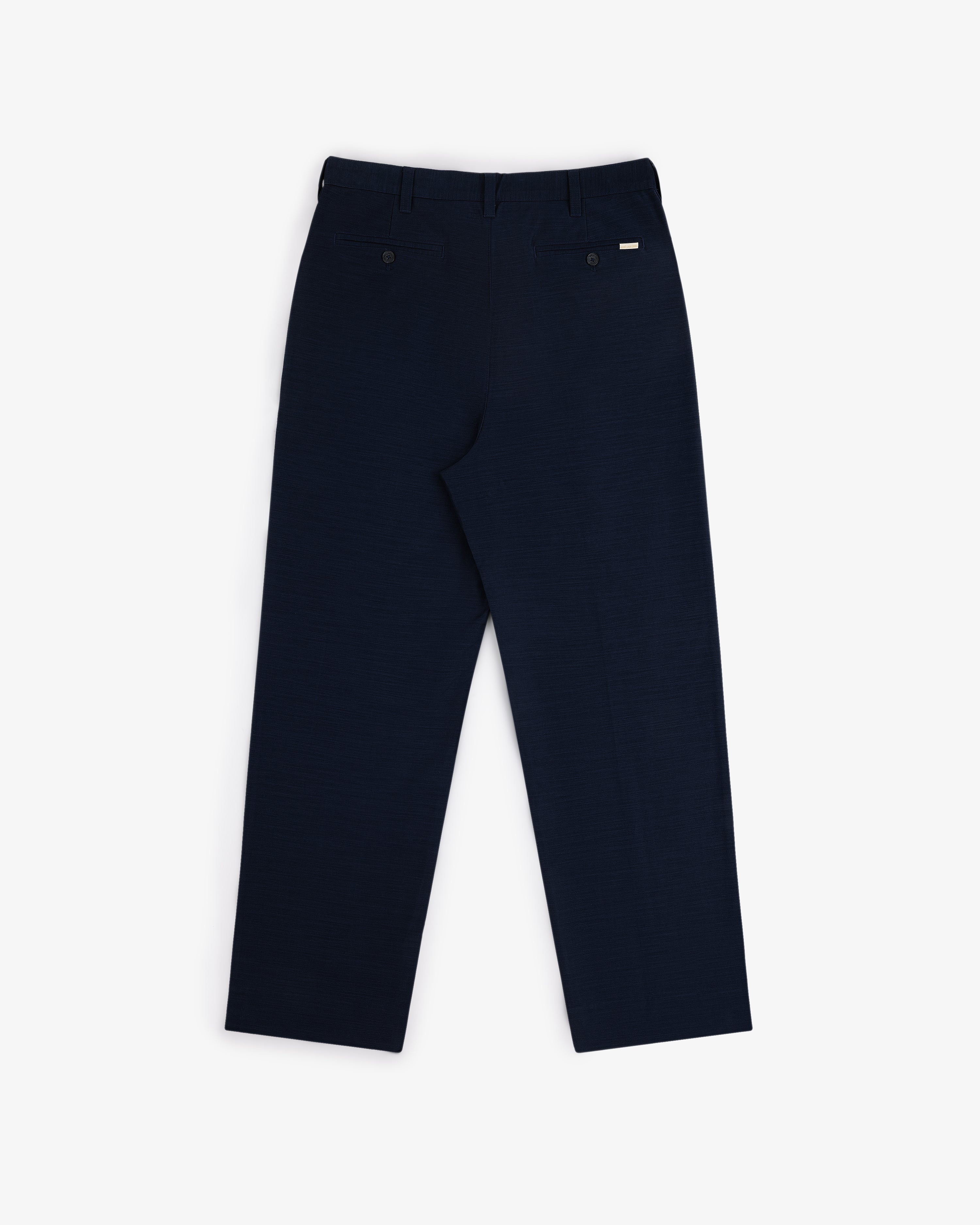 Double Pleated Pant in navy blue, shown from the back with two back pockets and a straight-leg fit.