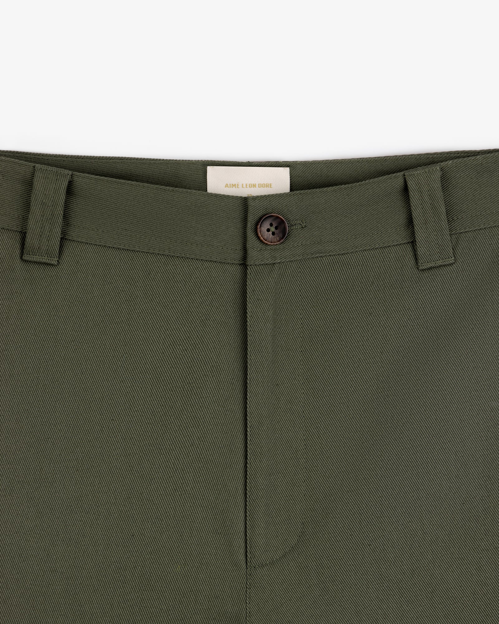 Close-up of Officer Pant in olive green with button closure and belt loops, shown from waist to upper thigh.