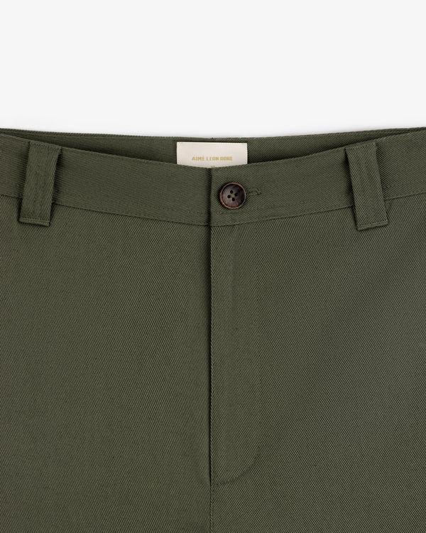 Close-up of Officer Pant in olive green with button closure and belt loops, shown from waist to upper thigh.